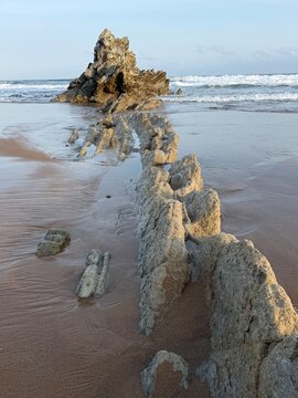 Aerial View of Flysch Rock Ridge Extending Across Sandy Beach, Sakoneta Beach, Basque Country
