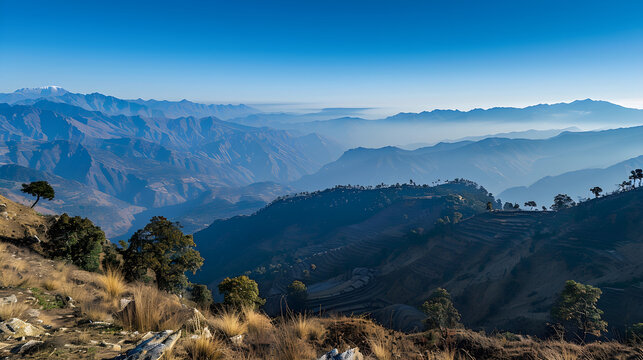 Panoramic view of the himalayan mountain range with terraced fields and morning mist in Nilgiri