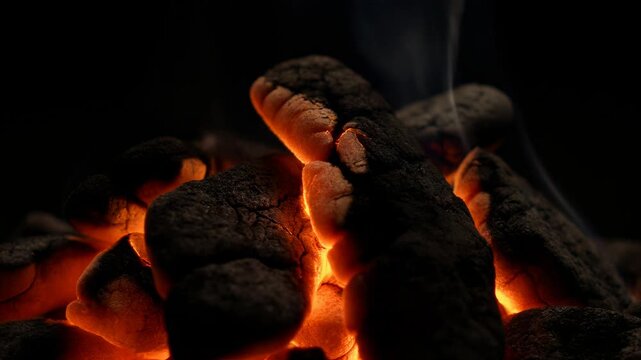 Glowing ember transition from burning coals to smoldering ash