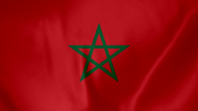Close up of the Moroccan flag with a green pentagram on a red background, waving gently