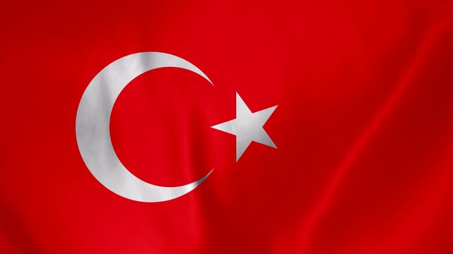 Close up of the Turkish flag waving with a crescent moon and star symbol in red and white fabric texture