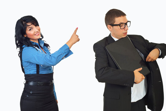 Woman points accusingly at man holding a folder
