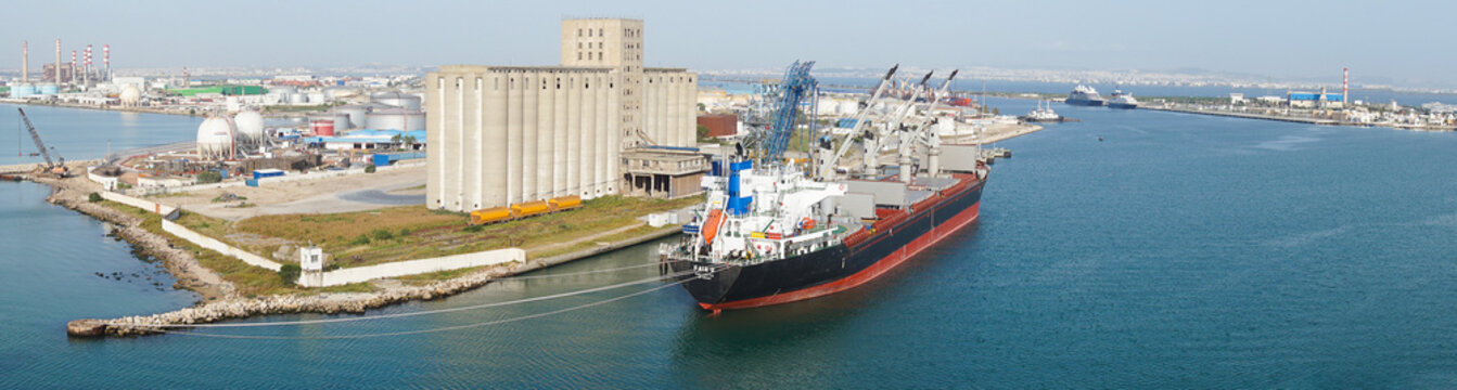 La Goulette, Tunisia - May 7, 2026: Seaport with a cargo ship moored next to a grain elevator in the port of La Goulette, Tunisia