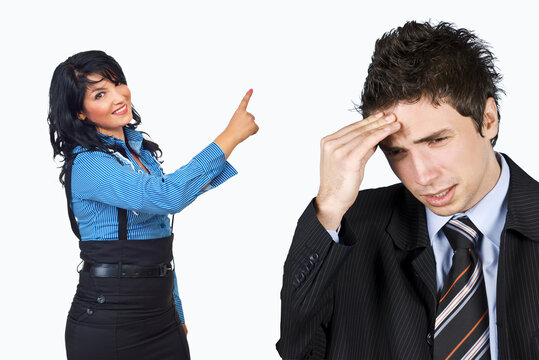 Woman points accusingly at stressed man