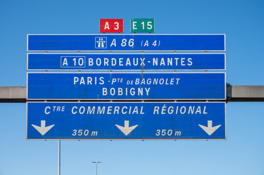 View of a French and European autoroute with overhead directional signs pointing to major cities like Paris, Bordeaux, Lille, Calais, showing lanes, traffic and motorway infrastructure, road signes