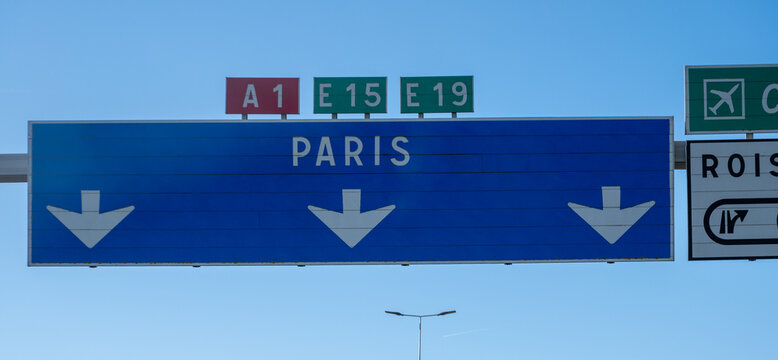 View of a French and European autoroute with overhead directional signs pointing to major cities like Paris, Bordeaux, Lille, Calais, showing lanes, traffic and motorway infrastructure, road signes