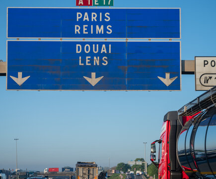 View of a French and European autoroute with overhead directional signs pointing to major cities like Paris, Bordeaux, Lille, Calais, showing lanes, traffic and motorway infrastructure, road signes