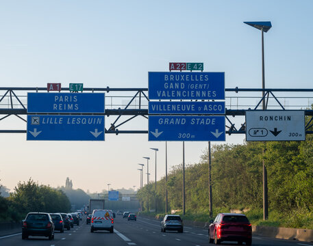 View of a French and European autoroute with overhead directional signs pointing to major cities like Paris, Bordeaux, Lille, Calais, showing lanes, traffic and motorway infrastructure, road signes