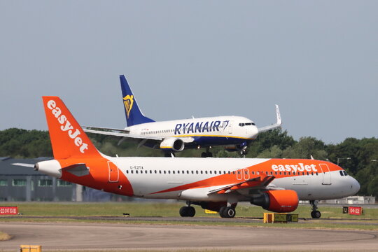 Ryanair Boeing 737 aircraft arriving, whilst an Easyjet aircraft waits to depart, at London Stansted Airport, Essex, UK on 30th May 2026
