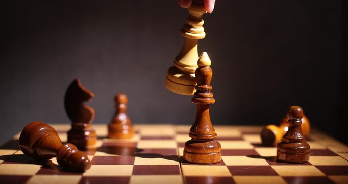 Wooden chess pieces on a dark board, close-up