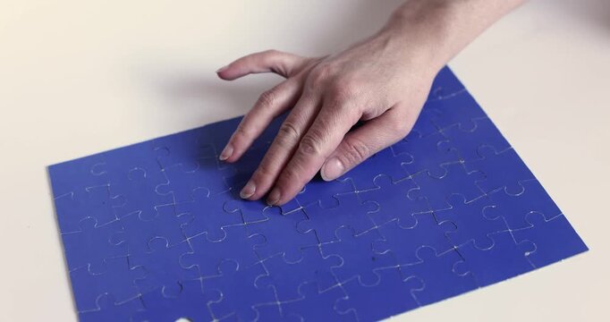 Blue velvet surface with a single jigsaw puzzle piece on top