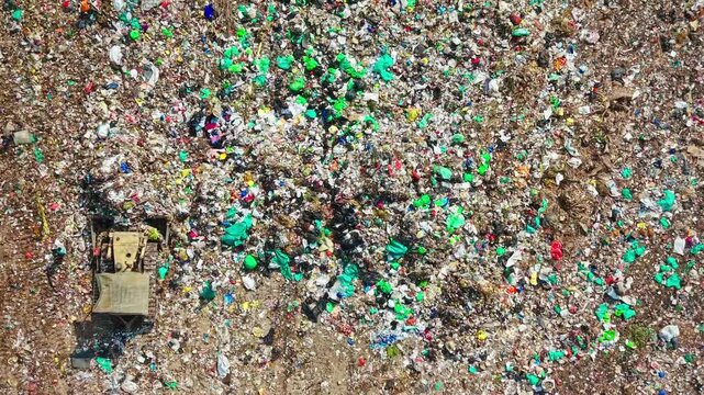 Bulldozer Pushing Municipal Waste At Large Landfill Site