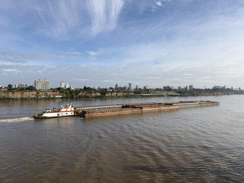 river tug boat push the empty barges. river and marine transport. city, urban landscape.