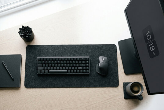 Minimalist modern workspace overhead view with keyboard and black accessories