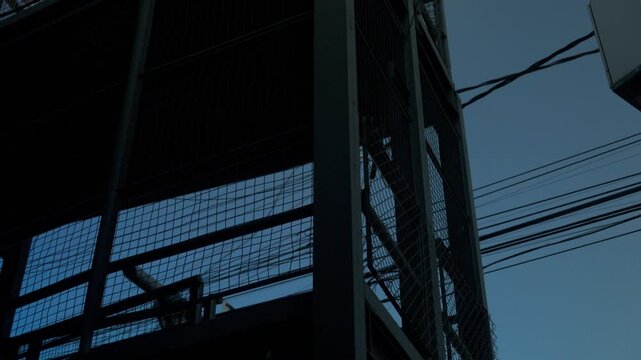 Urban landscape of Mexico City highway and skyscrapers seen through a blurry wire mesh fence