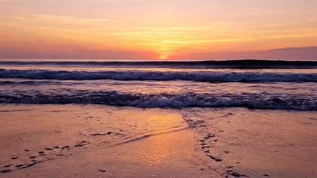 Serene ocean waves gently rolling onto a sandy shore during a sunset with warm orange and yellow hues reflecting on the wet sand and water surface creating a peaceful coastal scene Keywords