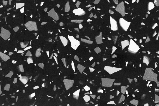 Black and white terrazzo pattern with irregular stone-like shapes and a texture background surface