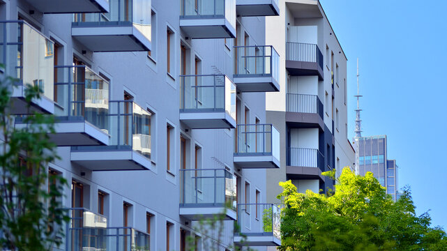 European residential architecture harmonizing with nature. Eco-friendly living in city with greens. Eco apartment building saving energy and fresh air concept. 