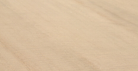 Smooth beige beach sand with soft diagonal lines as clean natural textured background © agrus