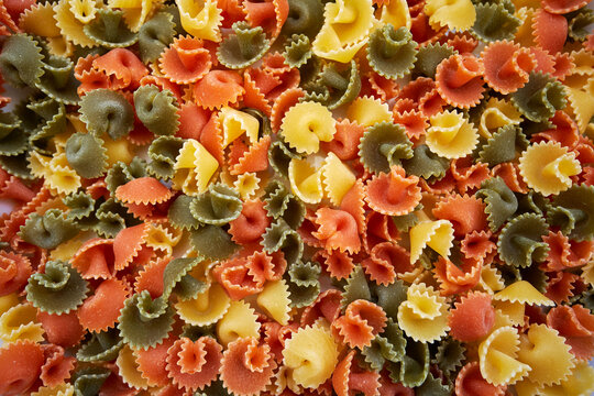 Colourful gluten free vegetable Margaritas pasta background. Top view.
