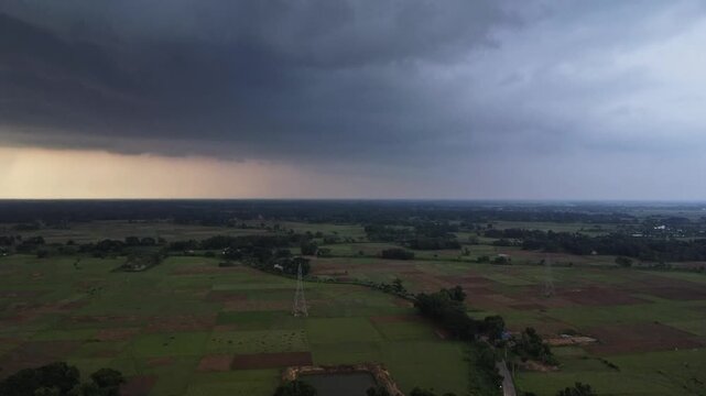 Aerial View of Dark Monsoon Rain Clouds Approaching Rural Agricultural Fields. View of Severe Weather and Rain Cloud Formation Over Countryside.