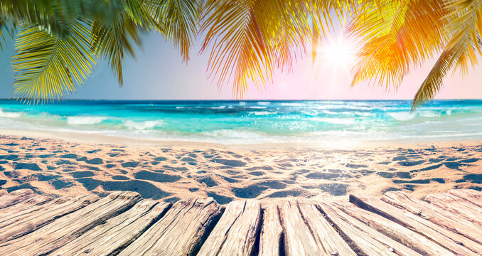 Palm Beach At Sunset With Defocused Background - Summer Vacation - Table And Sand With Blue Ocean - Abstract Blurred Lights - Glittering Effects
