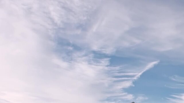 A breathtaking vista of the Arctic Ocean unfolds under an immense sky adorned with soft, ethereal clouds. This serene yet formidable landscape marks a moment of extreme travel.