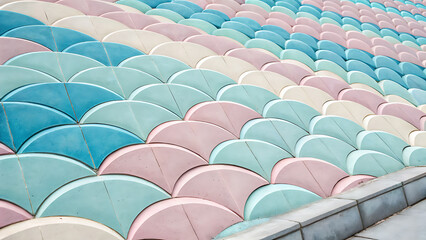 Obraz premium Colorful rows of pastel blue pink and white scalloped concrete stadium seating