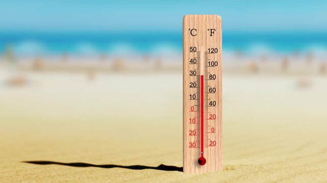 Wooden celsius and fahrenheit scale thermometer in the sand. Hot summer day