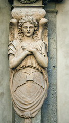 Obraz premium Guardian Angel Sculpture on a Historic Church Facade