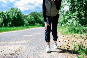 Fototapeta premium Young woman with knee pain during running.