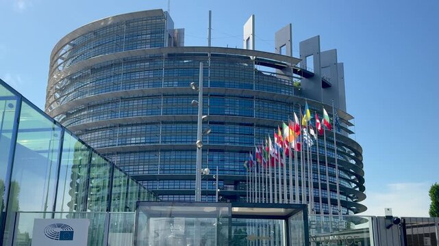 View of flags of various European countries waving in front of the Parliament building, Strasbourg, capital of Europe. 4K