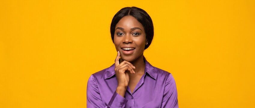 Excited young African American woman having a great idea or eureka moment. Brainstorming, solving a quiz, and finding a solution. Yellow banner with copy space