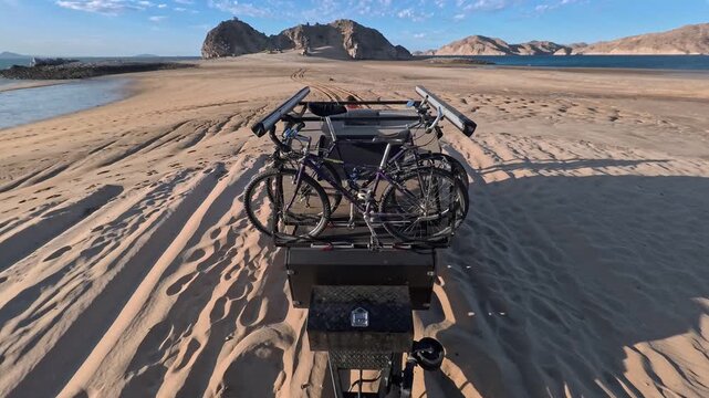 Towing a teardrop camper along the sandy beach in Gonzaga Bay Baja California for a camping trip and outdoor fun