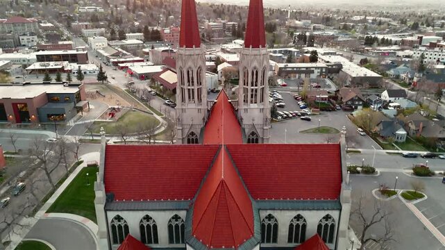 Aerial drone flight over red roof of Cathedral of Saint Helena in Montana