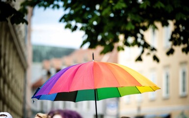 Vibrant rainbow umbrella outdoors on a sunny day during pride parade in Klagenfurt Austria © HelgaQ