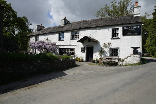 A traditional whitewashed Lakeland pub with wisteria, Broughton Mills, Lake District, Cumbria, England, UK. The Blacksmiths Arms dates back to 1577