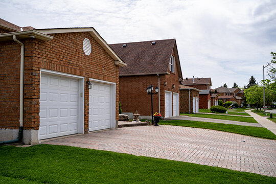 View of suburban residential homes with driveways and garages.