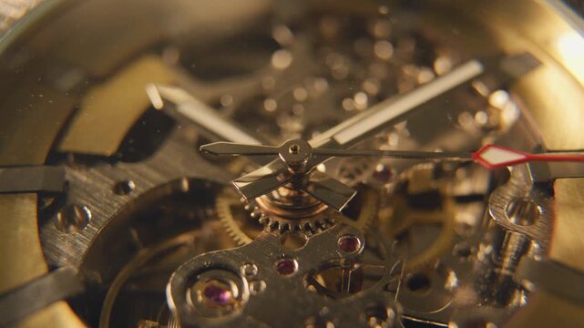 Close look at watch gears showing the detailed mechanism working inside a mechanical timepiece in a well-lit setting during the day