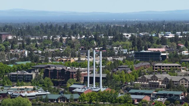 Aerial of flag in Old Mill district in smokestack in Bend Oregon in spring