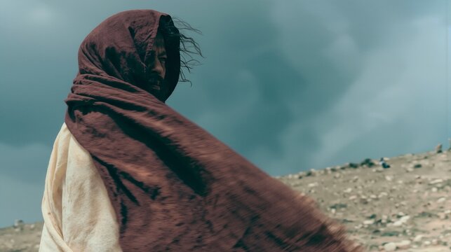 Elijah standing alone in the wilderness wearing windswept robes