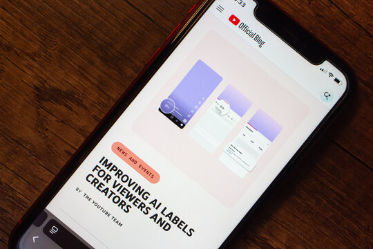 Mexico City, MEXICO - Jun 2 2026 : A smartphone shows the YouTube Official Blog page with the article Improving AI Labels for Viewers and Creators, illustrating AI disclosure interface mockups.