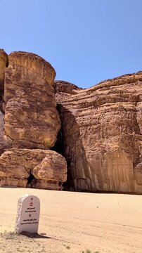 View from a moving vehicle's window showing the rocky mountains in a wild open space at Alula Saudi Arabia on a sunny day