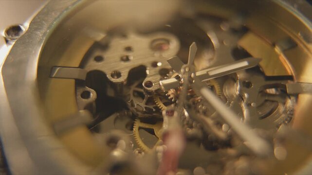 Close view of watch gears and mechanisms showing intricate details of timekeeping parts in motion during daylight hours