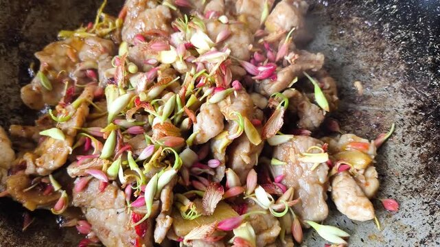Frying chopped pork with tamarind flowers, indoor Chiangmai Thailand.