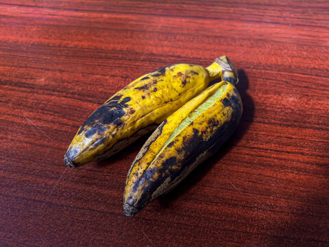 Delicious steamed bananas or pisang rebus, a traditional healthy food from Indonesia. Isolated by wooden background. Healthy food.