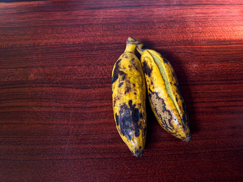 Delicious steamed bananas or pisang rebus, a traditional healthy food from Indonesia. Isolated by wooden background. Healthy food.
