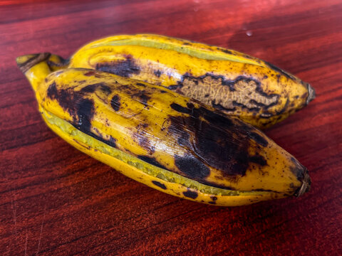 Delicious steamed bananas or pisang rebus, a traditional healthy food from Indonesia. Isolated by wooden background. Close up shot. Healthy food.
