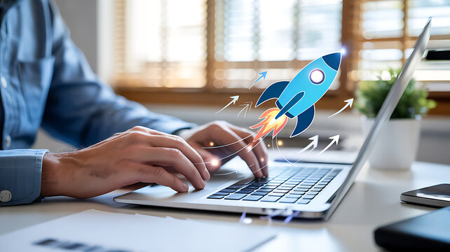 Person typing on laptop with blue rocket graphic and upward arrows business technology