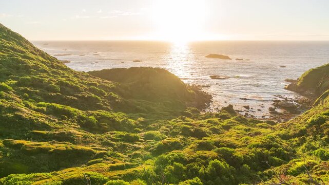 Day to night cinematic timelapse over lonely green cliffs in Chiloe Chile evoking peaceful mood awe and solitude under starry sky